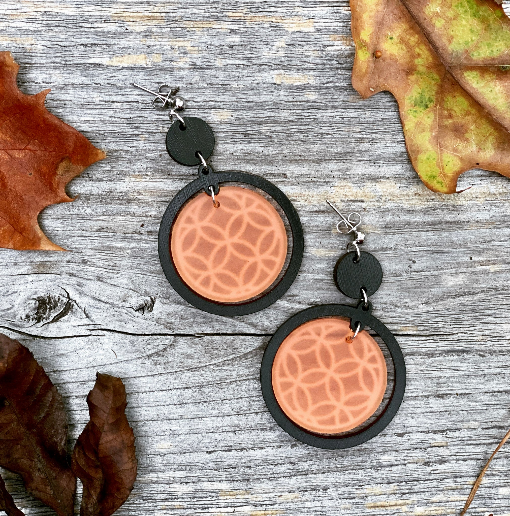 Marigold October Earring of the Month. Our two-part Marigold earrings are created with raven colored wood and opaque muted orange acrylic with engraved pattern.  Nickel free silver hardware posts. 